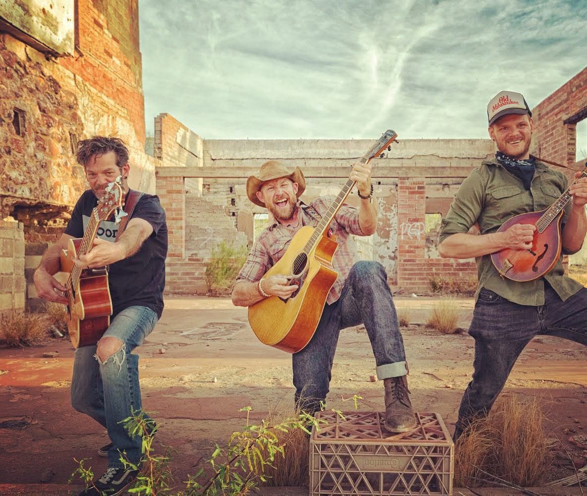 The Whiskey Treats, a three-piece, playing acoustic instruments among desert ruins